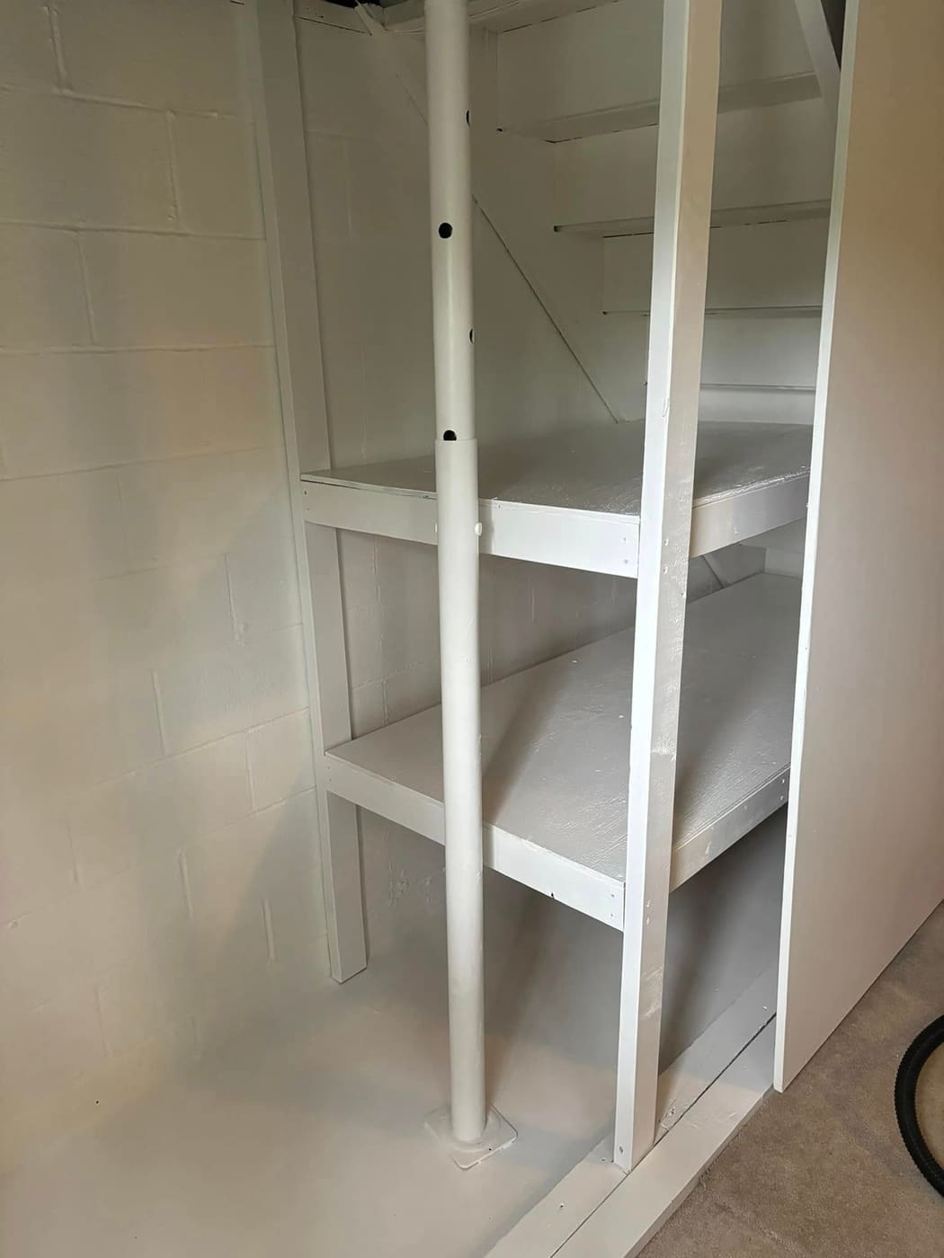 Repaired basement wall and new shelving, view 3