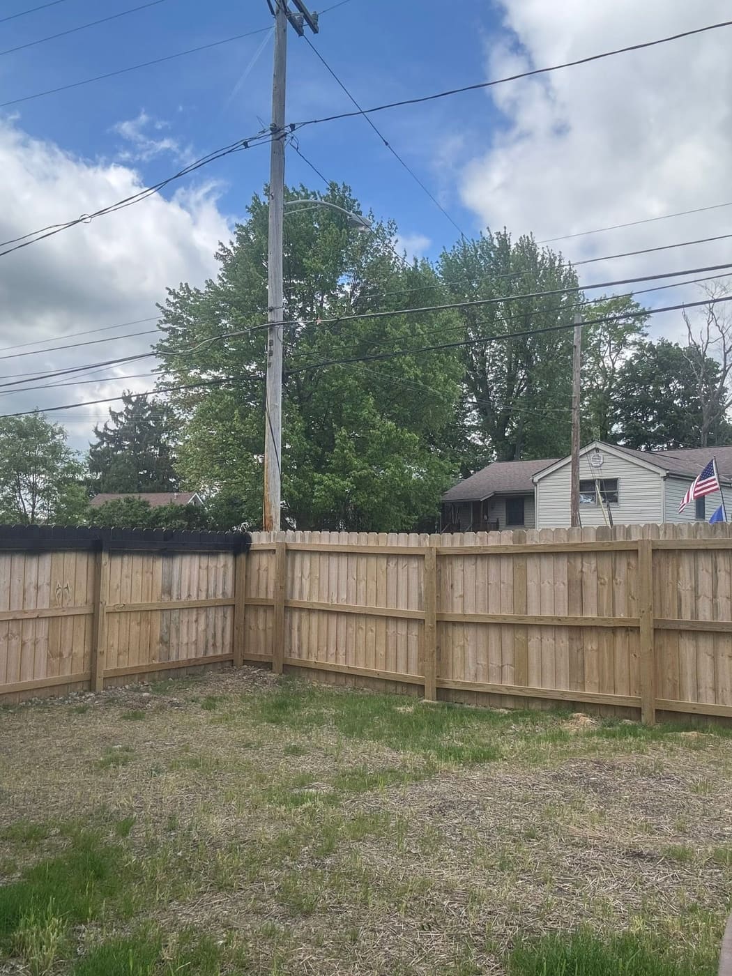 Wood privacy fence stained black