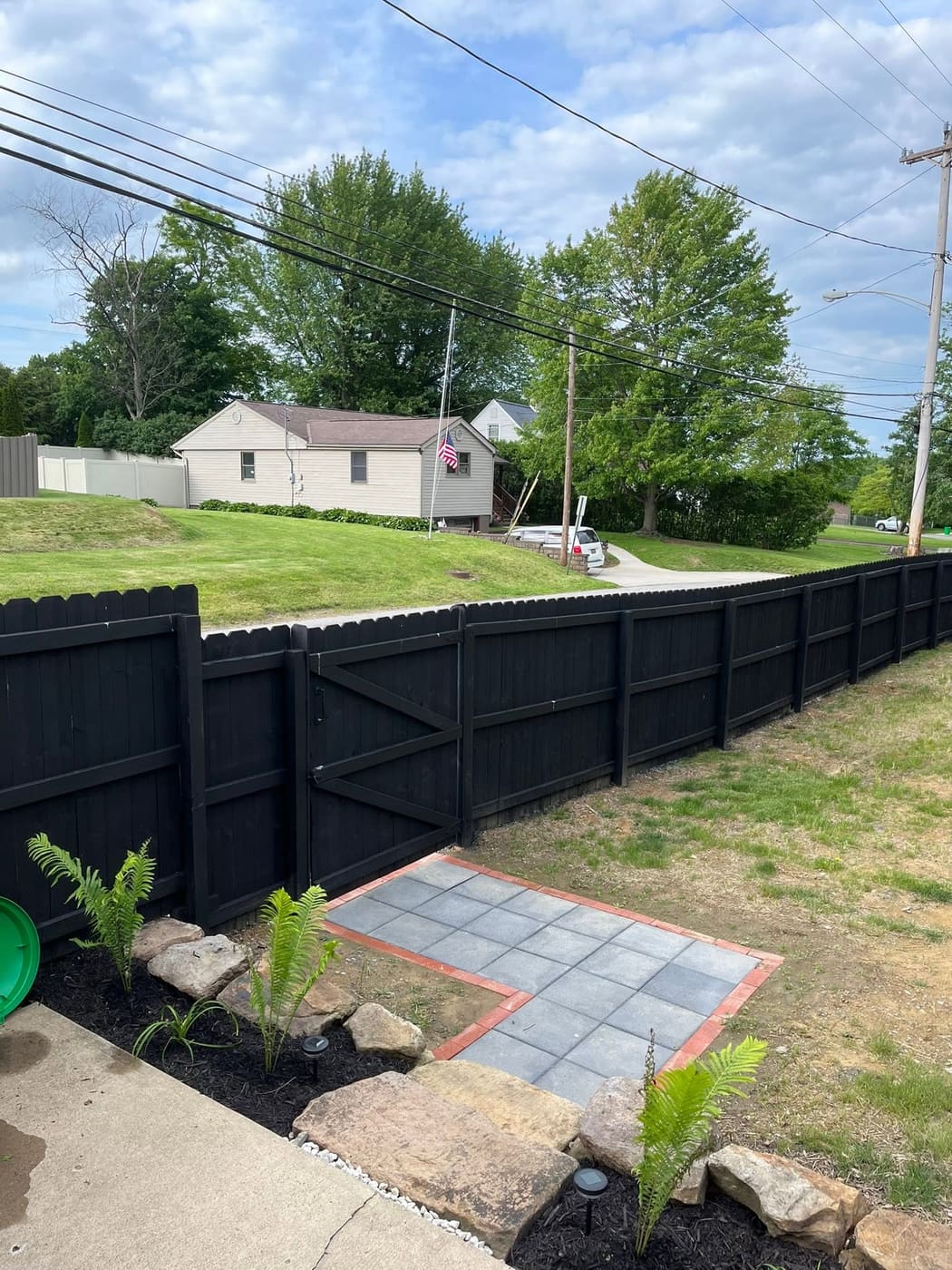 Wood privacy fence stained black, view 4