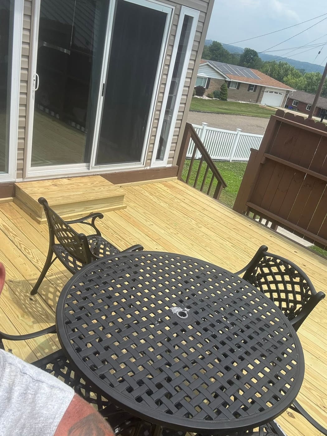 Rebuilt pressure-treated deck with patio furniture, view 2