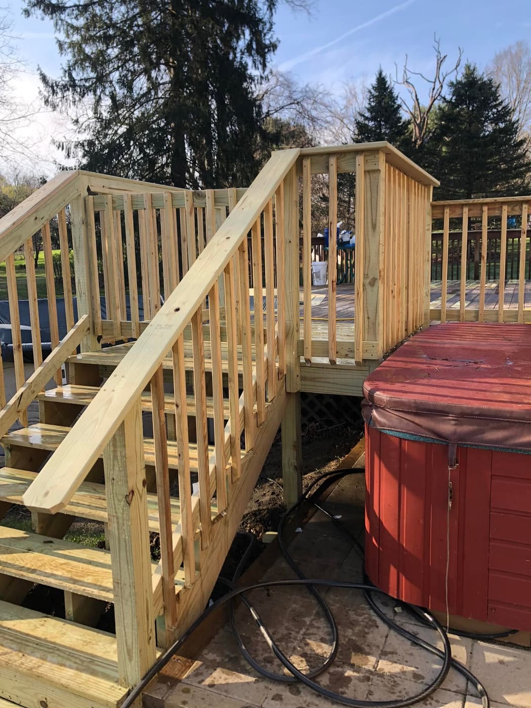 New deck stairs beside a hot tub