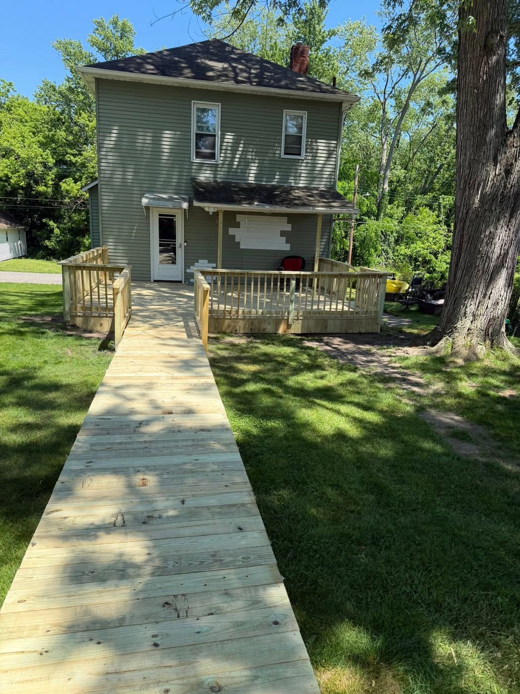 Long walkway ramp leading to a new back deck