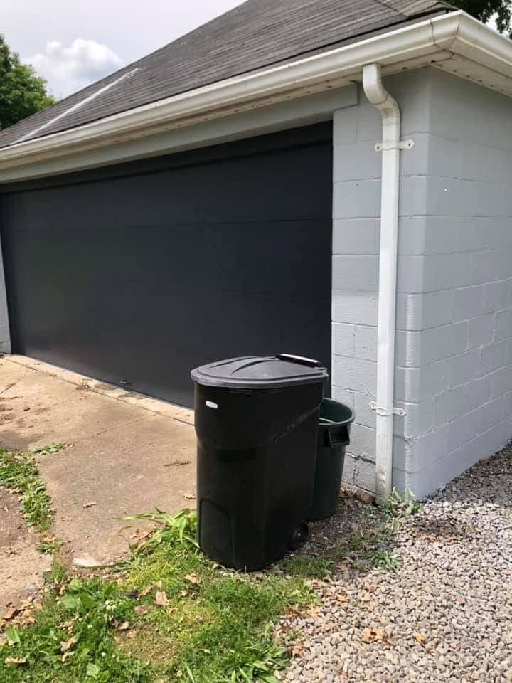 Garage painted white with dark doors, view 3