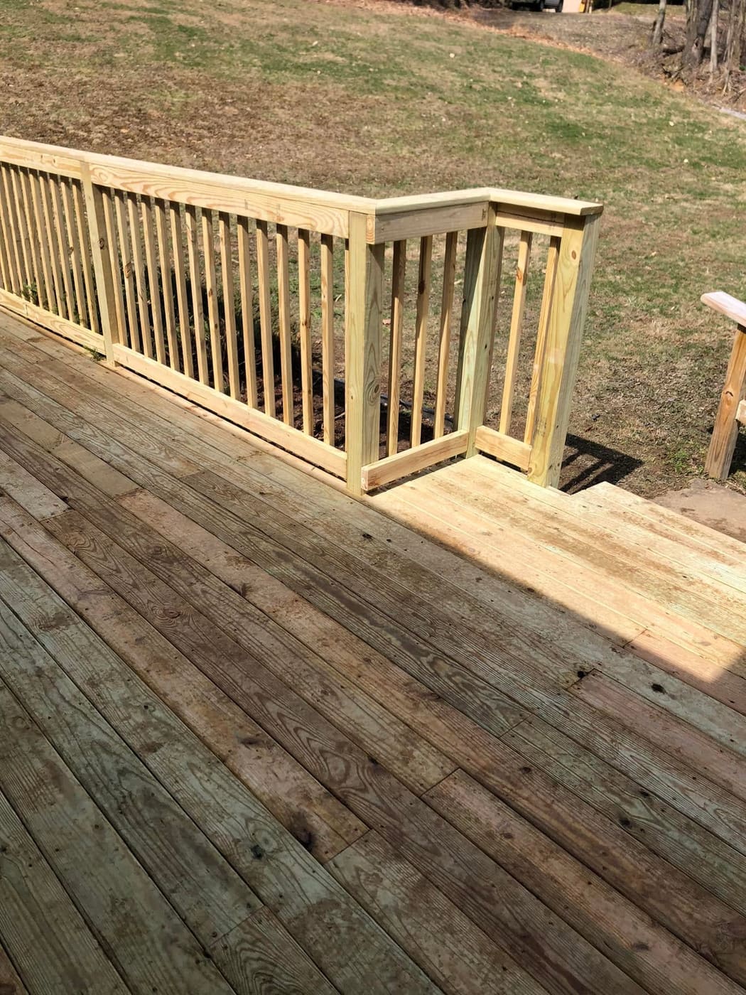 Low deck with railing along a house, view 4