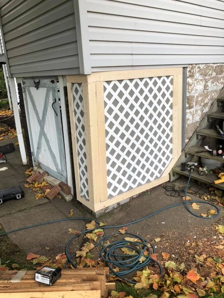 White lattice enclosure around an AC unit
