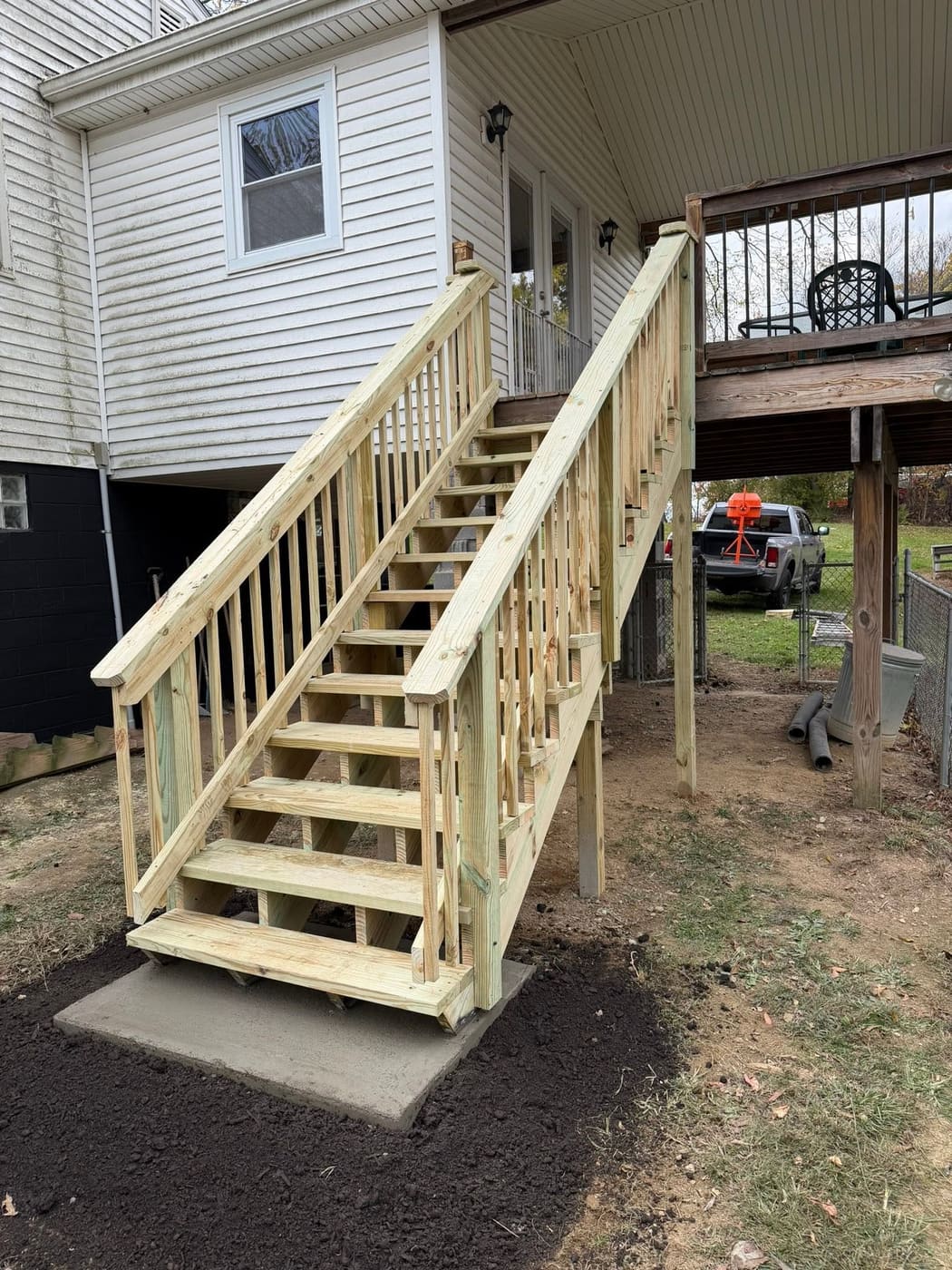 Long pressure-treated stairs up to a deck