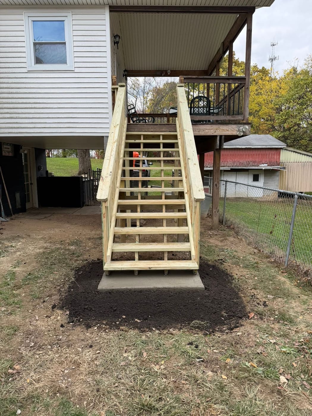 Long pressure-treated stairs up to a deck, view 2