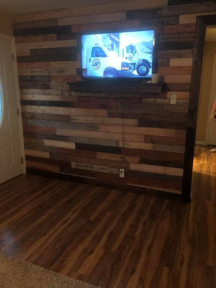 Reclaimed wood accent wall behind a TV