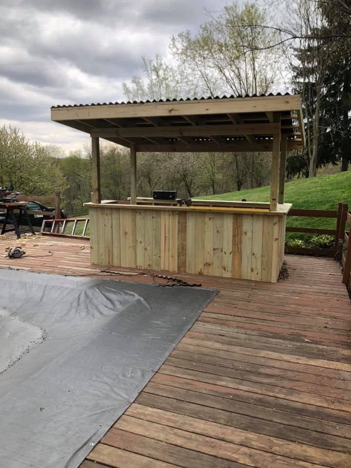 Covered tiki bar on a pool deck, view 2