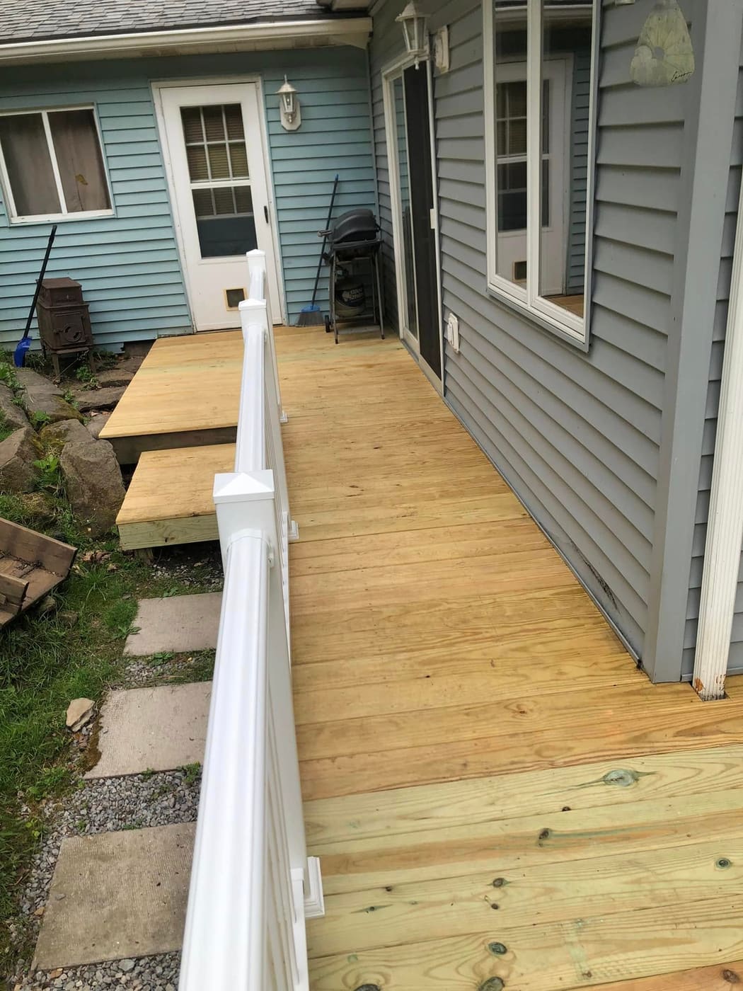 Pressure-treated ramp with white vinyl railing