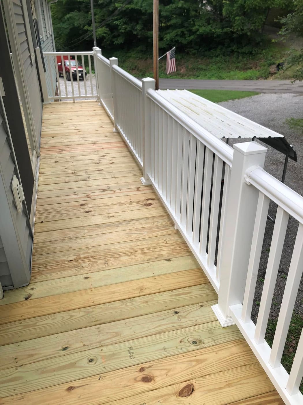 Pressure-treated ramp with white vinyl railing, view 2