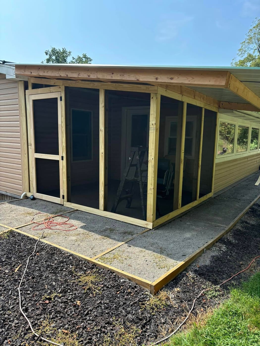 Covered porch enclosed with screens, view 3