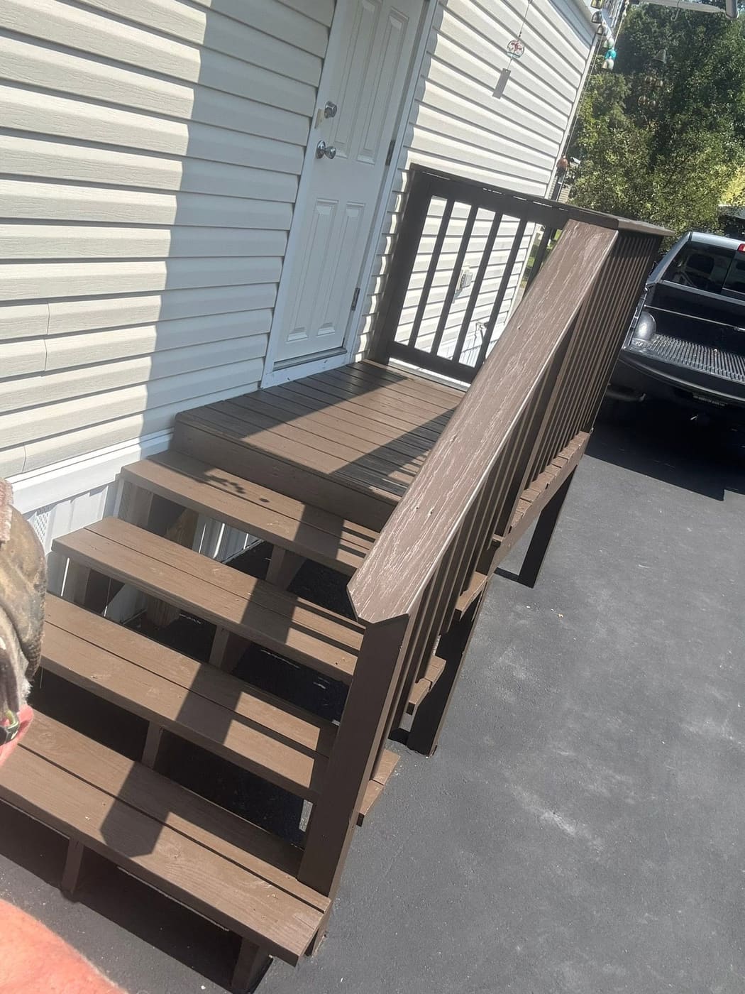 Stained entry steps with wood railing