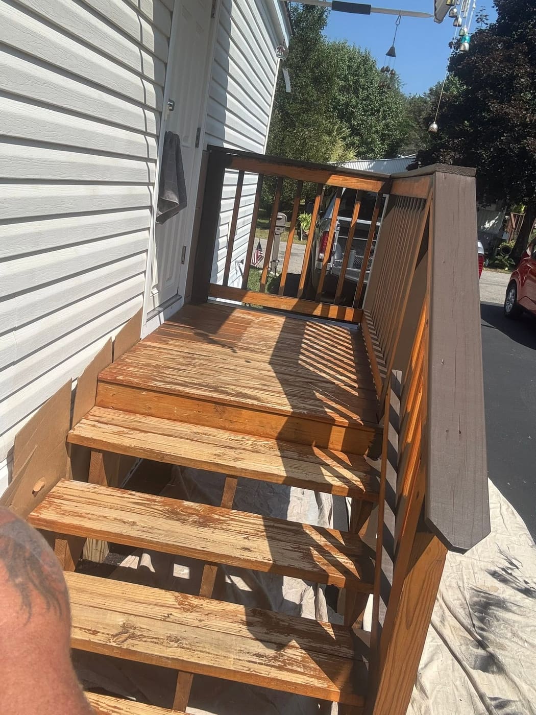 Stained entry steps with wood railing, view 2