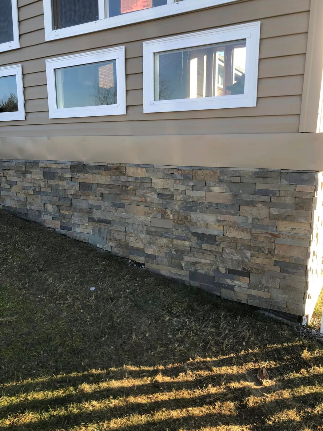 Stone veneer along a house foundation, view 3