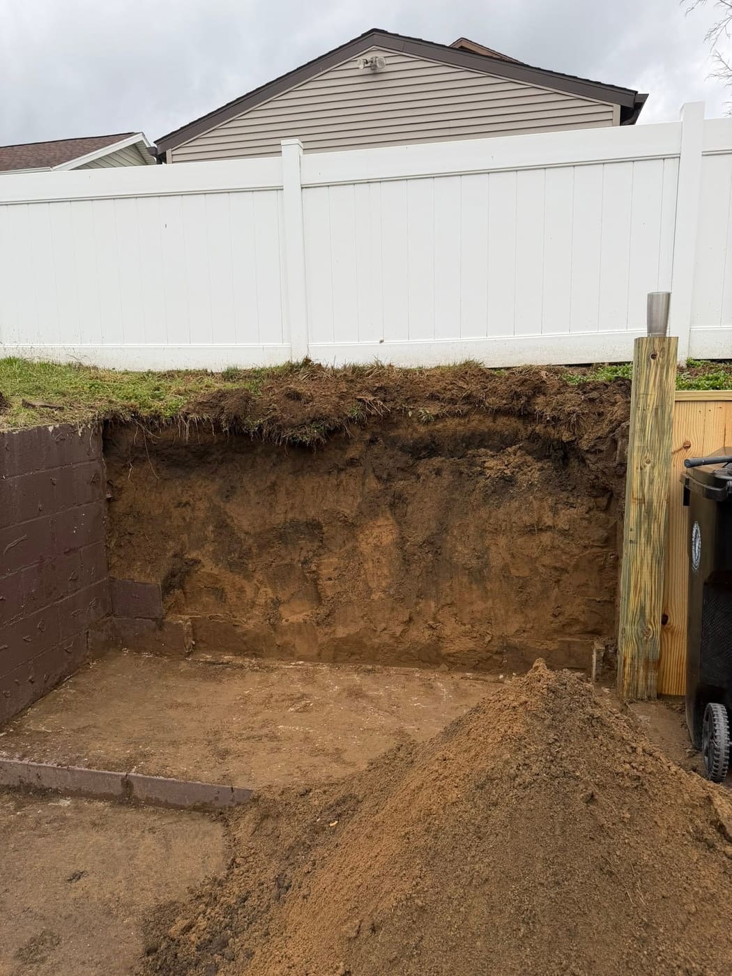 New timber retaining wall and stairs behind a house